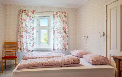 two beds in a bedroom with a window at Solvang in Hebnes
