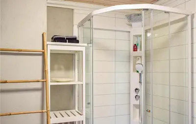 a shower with a glass door in a bathroom at Solvang in Hebnes