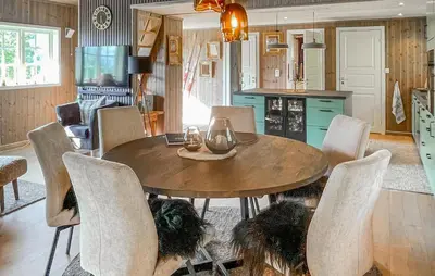 a dining room with a wooden table and chairs at Lovely Home In Rendalen With Wifi in Rendalen
