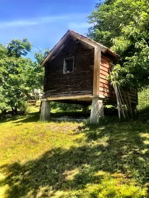 a small wooden house sitting in the grass at Gjørven Hytter in Flåm