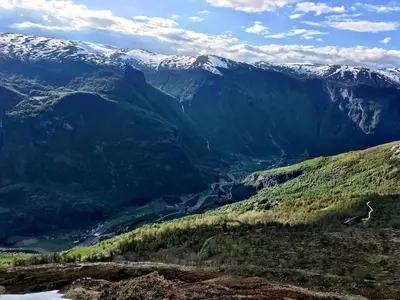 a mountain view of a valley with snow covered mountains at Gjørven Hytter in Flåm