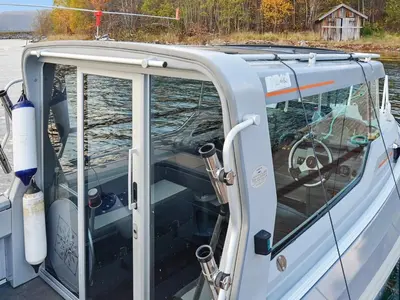 a boat with the door open on the water at Vintage Charm by the Sea-By Traum in Bø