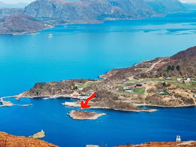 an island in the middle of a body of water at 10 person holiday home in Brattvåg in Brattvåg