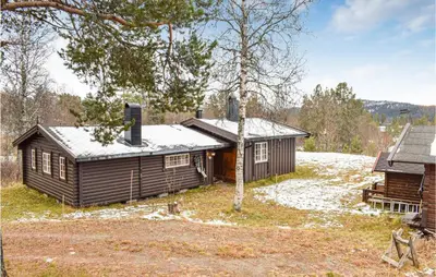 a log cabin with snow on the roof at Cozy Home In Rauland With Wifi in Rauland