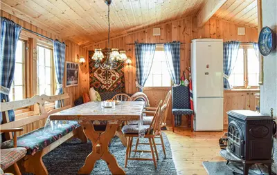 a dining room with a table and a refrigerator at Cozy Home In Rauland With Wifi in Rauland