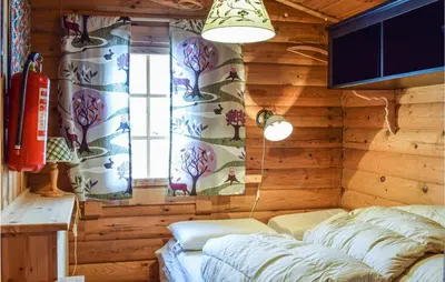a room with a bed and a window in a cabin at Cozy Home In Rauland With Wifi in Rauland