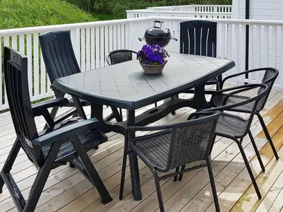 a black table and chairs on a deck at 10 person holiday home in Brattvåg in Brattvåg