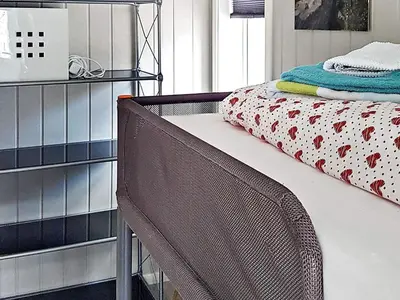 a bedroom with a bed with a metal frame at 10 person holiday home in Brattvåg in Brattvåg