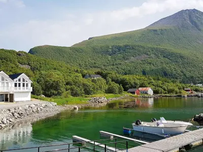 a couple of boats docked at a dock in a river at 10 person holiday home in Brattvåg in Brattvåg