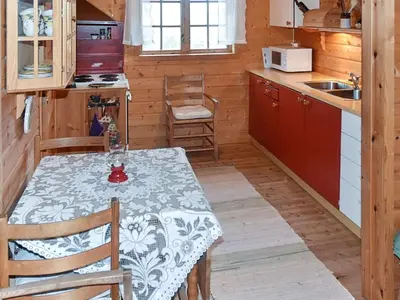 a kitchen with a table and a kitchen with a stove at 4 person holiday home in Leirvik i Sogn in Leirvik