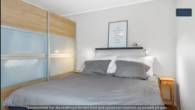 a bedroom with a bed with a large window at Central apartment in walking distance from the city. in Ålesund