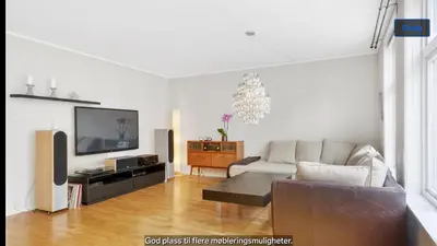 a living room with a couch and a flat screen tv at Central apartment in walking distance from the city. in Ålesund