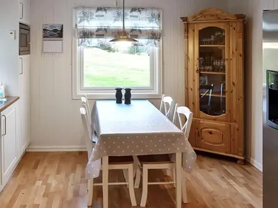 a dining room with a table and chairs at 10 person holiday home in MIDSUND in Midsund