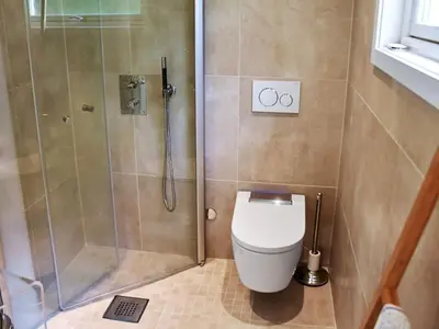 a bathroom with a shower and a toilet at 10 person holiday home in MIDSUND in Midsund