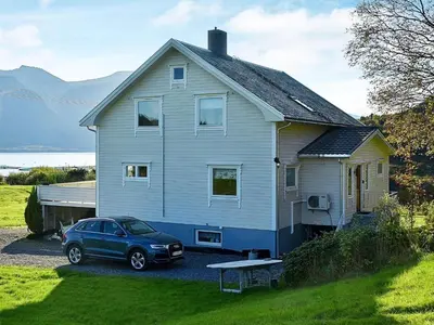 a blue car parked in front of a house at 10 person holiday home in MIDSUND in Midsund