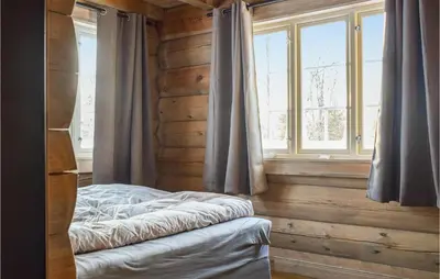 a bedroom with a bed in front of a window at Pet Friendly Home In Hovden I Setesdal in Hovden