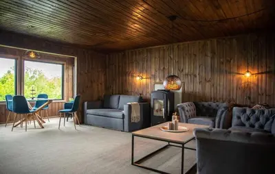 a living room with a couch and chairs and a table at Atlantic View Ingerstua in Frei
