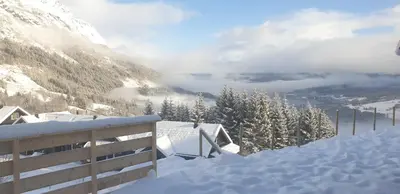 a snow covered mountain with a view of a valley at New and Exclusive Cottage in Voss with a great view in Skulestadmo