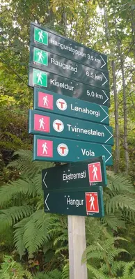 a street sign with many signs on a pole at New and Exclusive Cottage in Voss with a great view in Skulestadmo