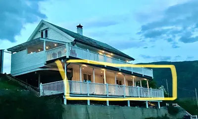 a house with a large balcony on the side of it at Two bedroom apartement in Sogndal