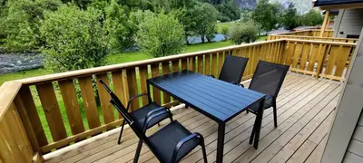 a blue table and four chairs on a deck at Lunde Camping in Aurland