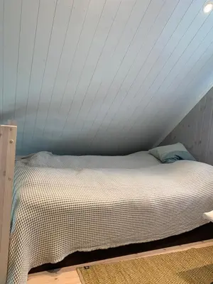 a bed in a room with a white ceiling at The Gingerbread House in Lillehammer