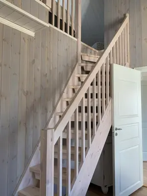 a staircase in a house with wooden walls at The Gingerbread House in Lillehammer
