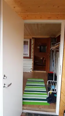 a room with a green and white rug on the floor at Leilighet 2240 in Haugsvær