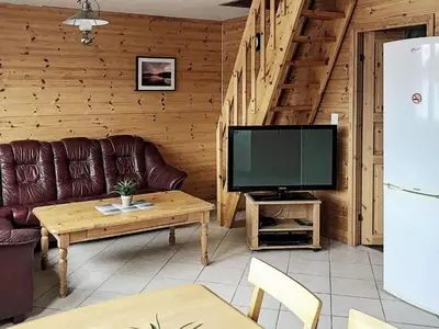 a living room with a couch and a television at 6 person holiday home in Seim in Seim