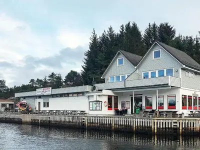 a building on a dock next to the water at 6 person holiday home in Seim in Seim
