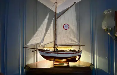 a model of a boat on a table with a clock at Villa Edvin - Slow living in Eide