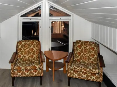 two chairs and a table in a room at 6 person holiday home in Lyngstad in Lyngstad