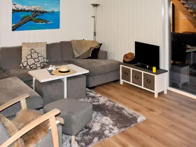 a living room with a couch and a tv at 6 person holiday home in Lyngstad in Lyngstad