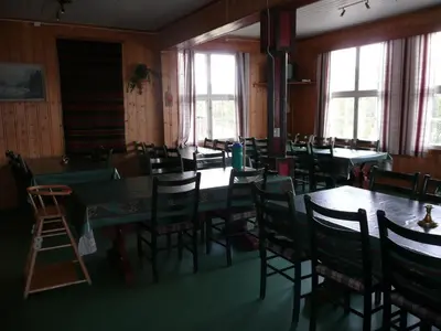 an empty dining room with tables and chairs at Jønndalen Høyfjellseter in Uvdal
