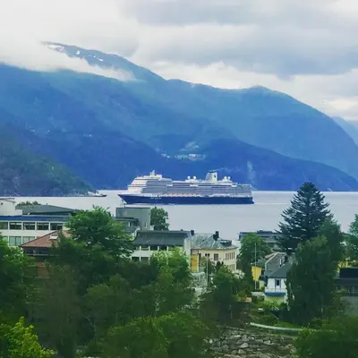 a cruise ship in a large body of water at Villa Lovise Riverside in Stranda