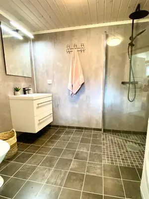 a bathroom with a shower and a sink at Villa Lovise Riverside in Stranda
