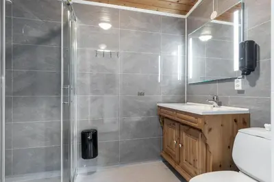 a bathroom with a shower and a toilet and a sink at Topcamp Rustberg - Hafjell in Hafjell