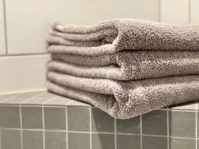 a pile of towels sitting on top of a bathroom counter at Apartment Lilletveitvegen in Bergen