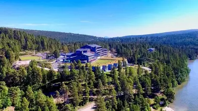 an aerial view of a house on a hill next to a river at Savalen Fjellhotell & Spa in Tynset