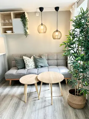 a living room with a couch and two tables at Nedre Stølen Apartment Bergen in Bergen