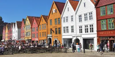 a group of people walking on a street with buildings at Nedre Stølen Apartment Bergen in Bergen