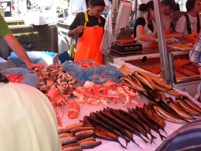 a group of people standing around a table with seafood at Nedre Stølen Apartment Bergen in Bergen