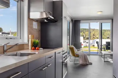 a kitchen with a sink and a large window at Topcamp Mjøsa - Brumunddal in Brumunddalen