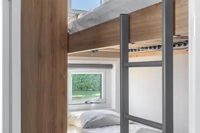a bunk bed in a room with a window at Topcamp Mjøsa - Brumunddal in Brumunddalen