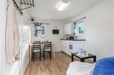 a kitchen and dining room with a table and chairs at Topcamp Mjøsa - Brumunddal in Brumunddalen