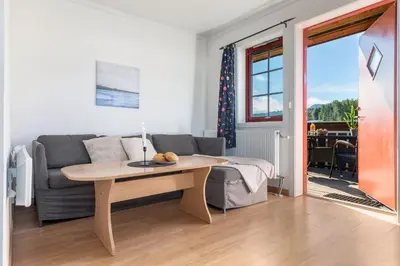a living room with a table and a couch at Topcamp Mjøsa - Brumunddal in Brumunddalen