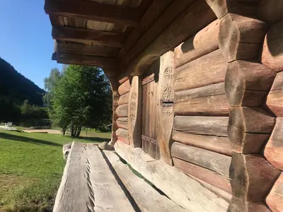 a log cabin with a wooden wall at Sevletunet B&B and Cabins in Rødberg