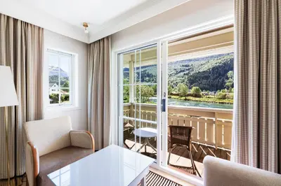 a hotel room with a view of a balcony at Hotel Loenfjord Loen in Loen