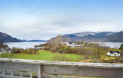 a view of a lake and houses with mountains at Cozy Home In Etne With Wifi in Kyrping