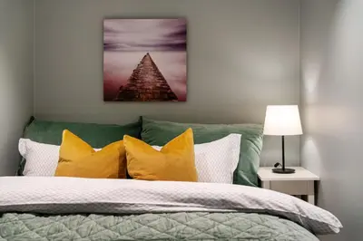 a bedroom with a bed with yellow pillows at Keyser Apartments 6 in Bergen